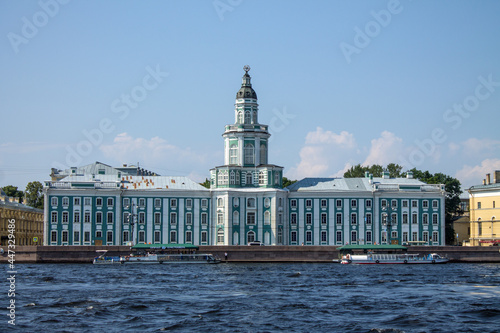 the facade of the beautiful palace-the famous anthropological museum of the Kunstkamera on the University embankment near the Neva River on a sunny summer day in Saint-Petersburg photo