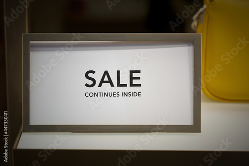 Sign in a shop window in Berlin with the words Sale continues inside 