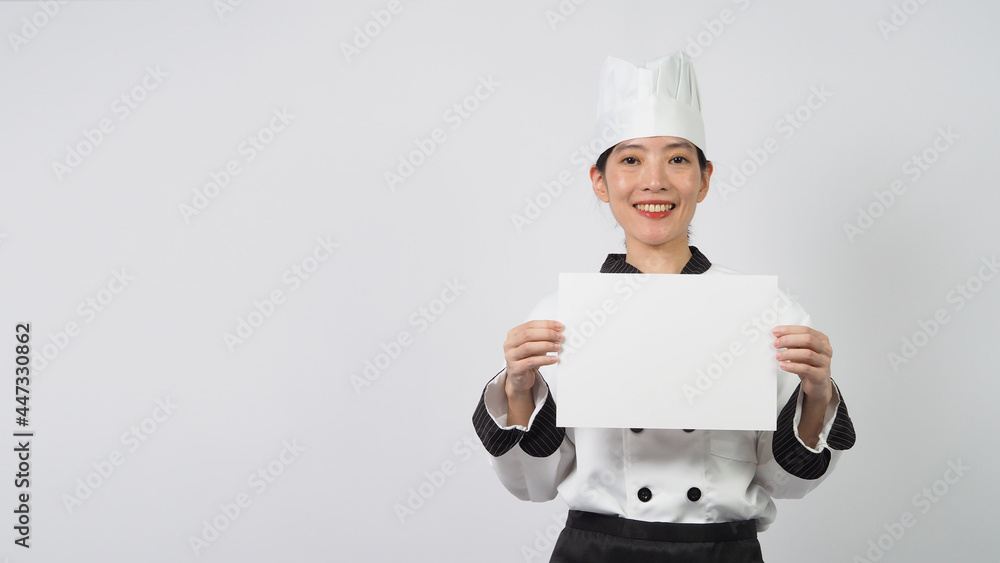 Woman wearing chef uniform and holding blaNK A4 paper on white background. Woman wearing chef uniform and holding blaNK A4 paper on white background.