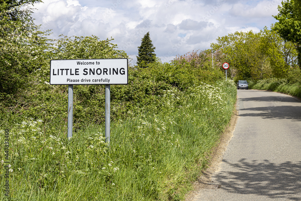A road sign welcoming people to the village of Little Snoring, Norfolk, England UK