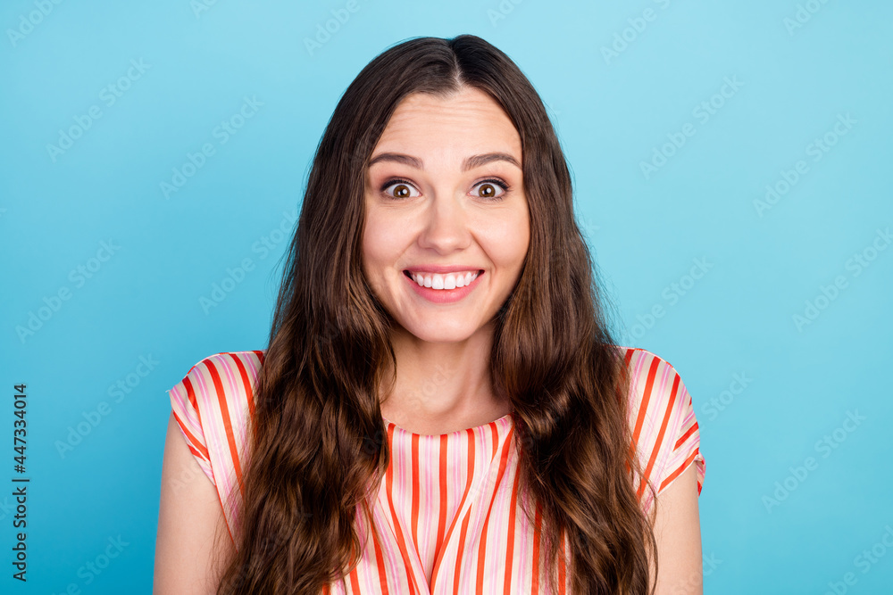 Fototapeta premium Photo of amazed adorable lady toothy beaming shiny smile wear striped blouse isolated blue color background