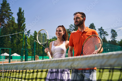 Two sporty young people with rackets looking into the distance © Viacheslav Yakobchuk