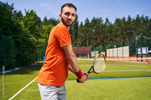 Focused tranquil tennis player preparing to return the serve © Viacheslav Yakobchuk
