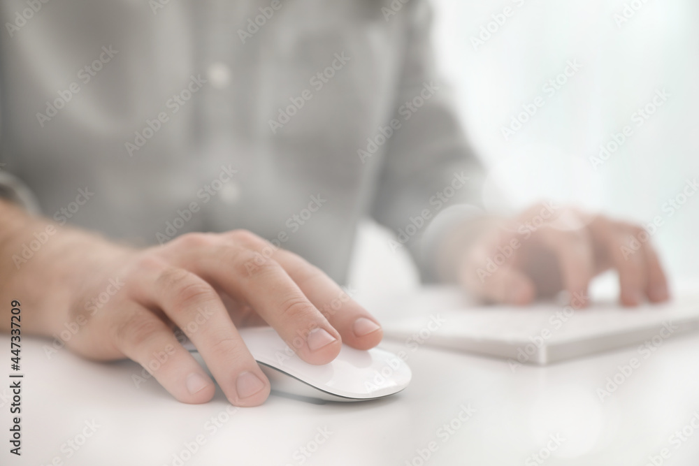 Man using computer mouse at desk, closeup Man using computer mouse at desk, closeup