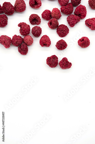 Home cooked, dehydrated raspberry berries. Dried, organic raspberries. Abstract background of raspberry chips - superfood, berry fruit dessert on the white desk. 
