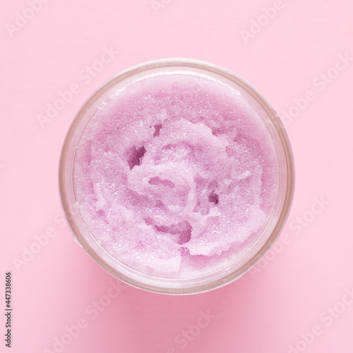 Cosmetic scrub for face and body on a pink background. Beauty concept. Top view.