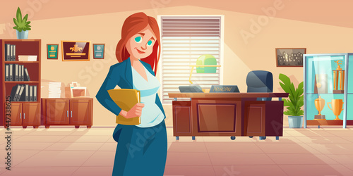 Woman principal in school office with desk, c