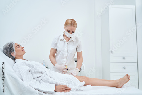 Pleased female person doing beauty procedure in salon