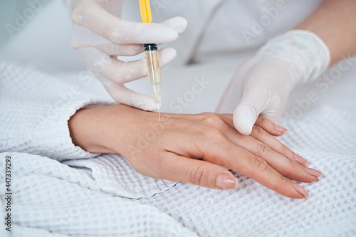 Kind female person doing professional skincare procedure