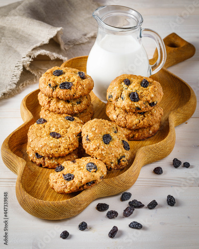 Fresh baked homemade oatmeal cookies with raisins and sunflower seeds on wooden background