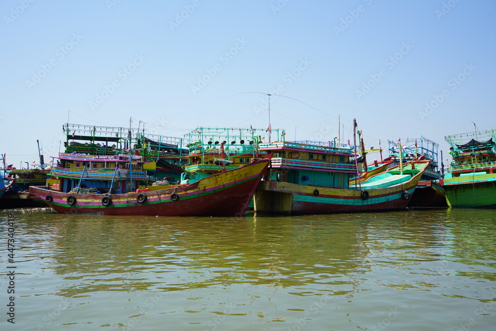 A wooden fishing boat is parked at the mouth of the Juwana River, Pati, Central Java, Indonesia.