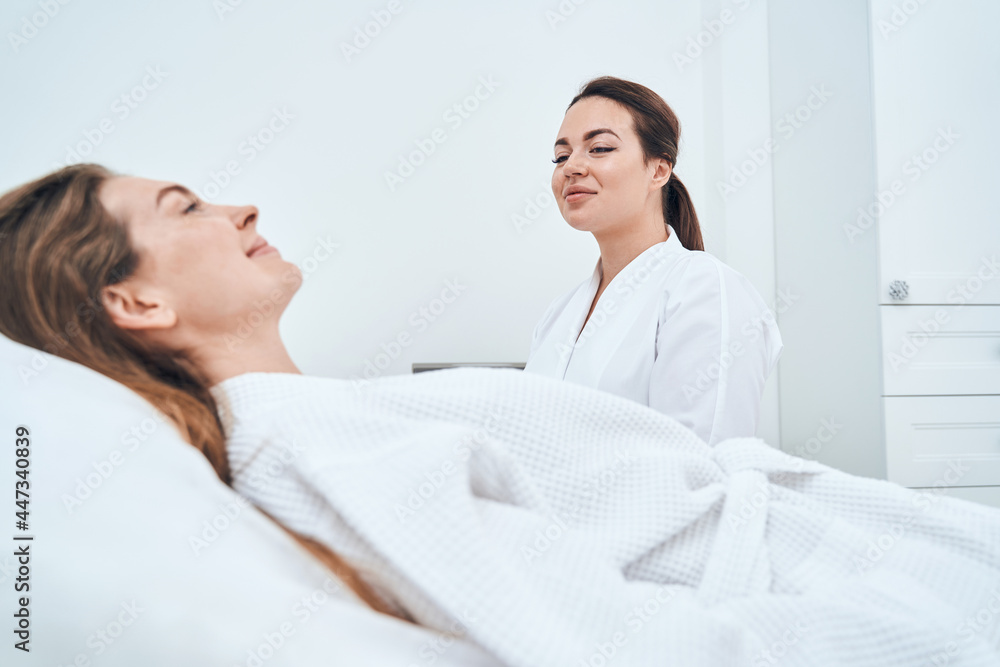 Fototapeta premium Positive delighted female person lying on couch