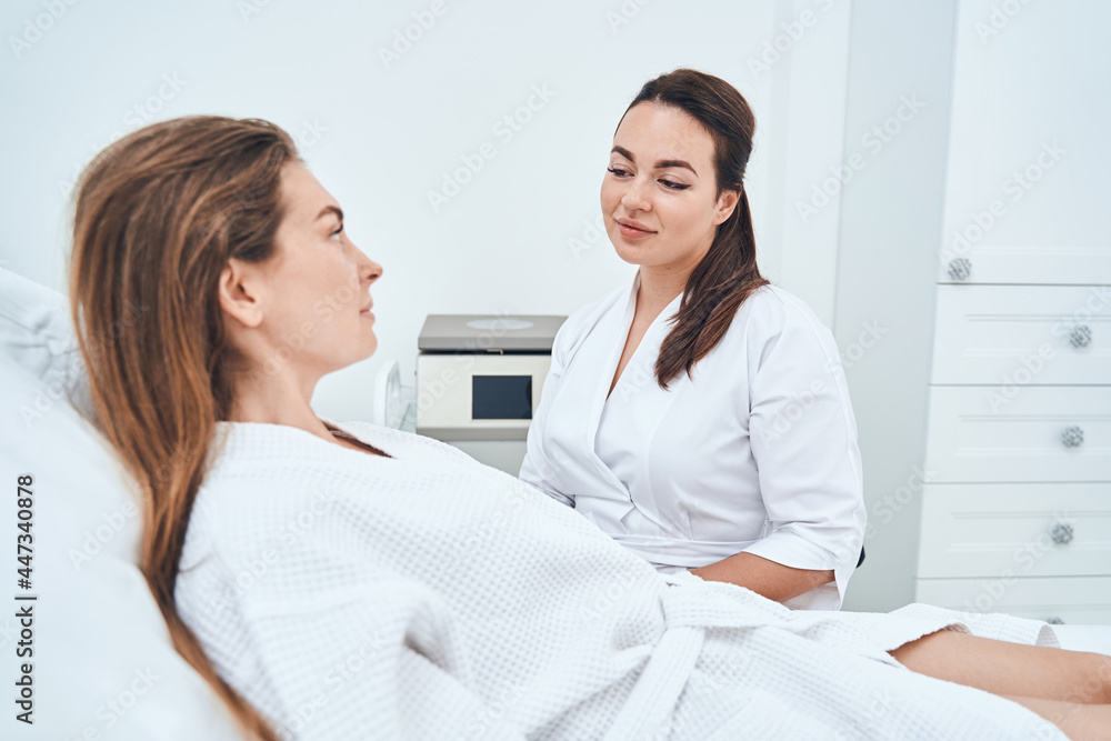 Fototapeta premium Concentrated female patient looking at her specialist