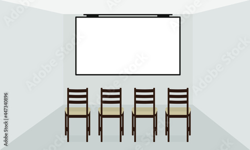 A screen hanging on the wall and four chairs in an empty room