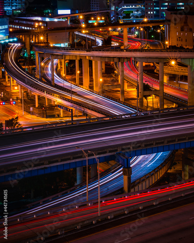 busy highway showing light trails of traffic at night