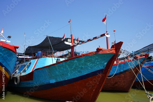 A wooden fishing boat is parked at the mouth of the Juwana River, Pati, Central Java, Indonesia. © Faris Fitrianto