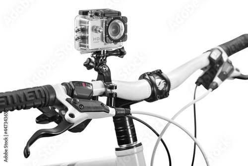 Silver action camera attached to a bicicle handlebar inside a waterproof box on white background photo
