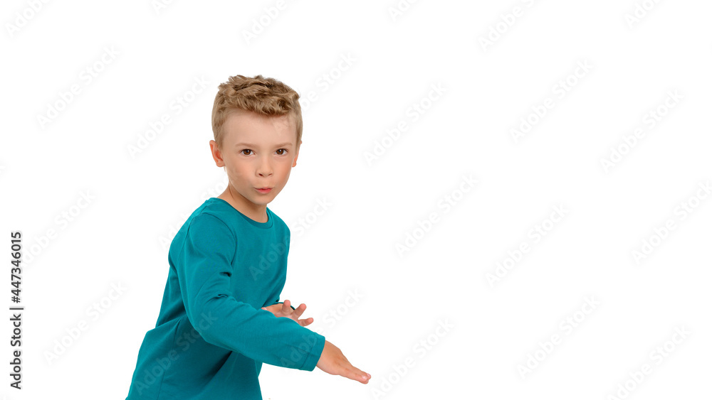 The little boy is celebrating and dancing. Child dressed in birch long sleeve, white isolated background, studio portrait The little boy is celebrating and dancing. Child dressed in birch long sleeve, white isolated background, studio portrait