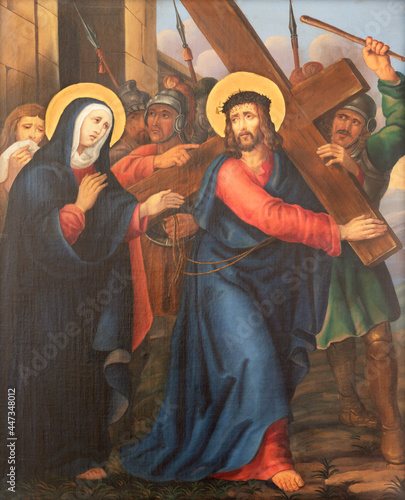 VIENNA, AUSTIRA - JUNI 17, 2021: The painting Simon of Cyrene helps Jesus carry the cross as part of Cross way stations in church Rochuskirche by unknown artist.
