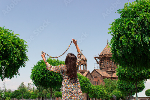 A girls scarf is playing with the wind