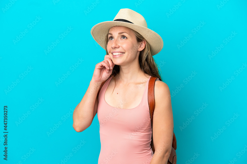 Young caucasian woman in summer holidays isolated on blue background thinking an idea while looking up Young caucasian woman in summer holidays isolated on blue background thinking an idea while looking up