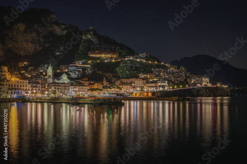 Wide panoramic view of Amalfi at night, Campania region, Italy.