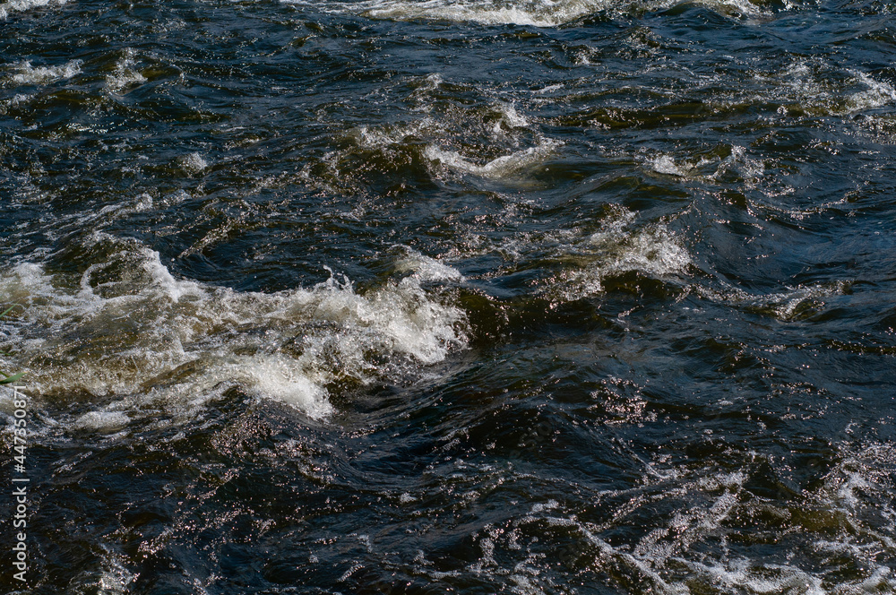 Fast flowing cold water mountain stream, flowing stormy stream stream, nature outdoors, fresh stream dark blue water Fast flowing cold water mountain stream, flowing stormy stream stream, nature outdoors, fresh stream dark blue water