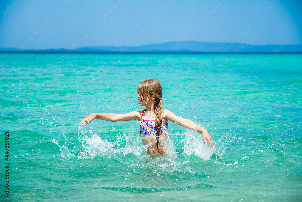 happy child at sea in greece plays in nature