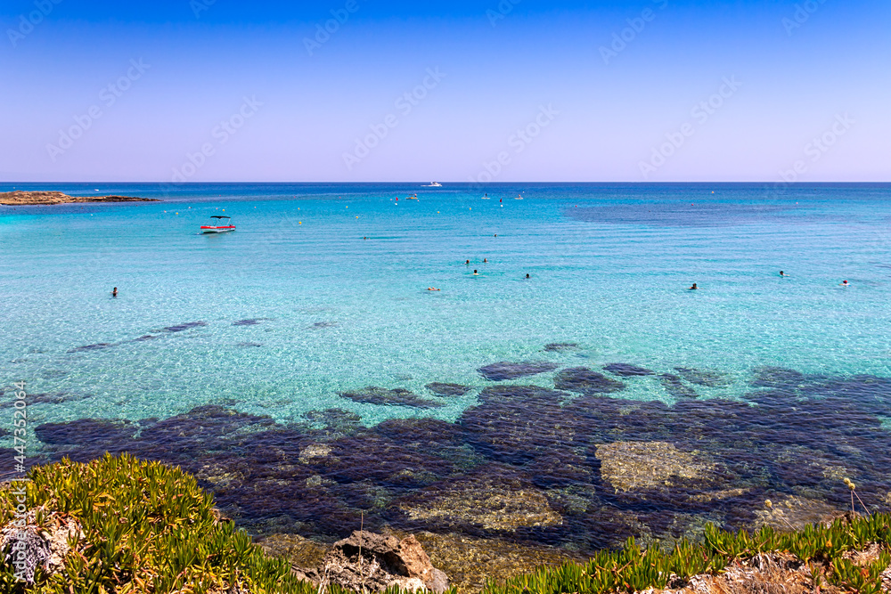 View of the Mediterranean Sea with clear water. The rocky coast of the resort village of Protaras on the island of Cyprus.