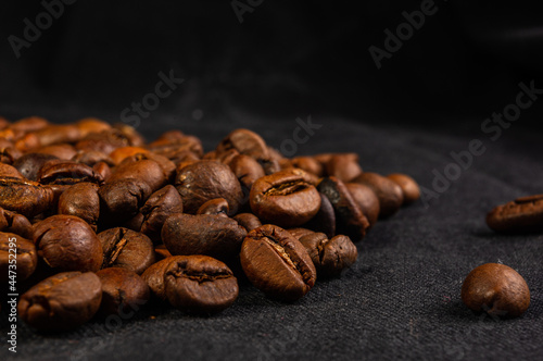 Natural background for Cafe menu or brochure template - macro photo of brown roasted coffee beans, close up