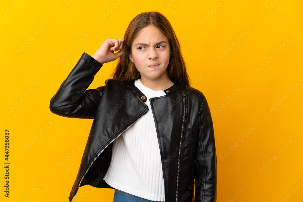 Child over isolated yellow background having doubts Child over isolated yellow background having doubts