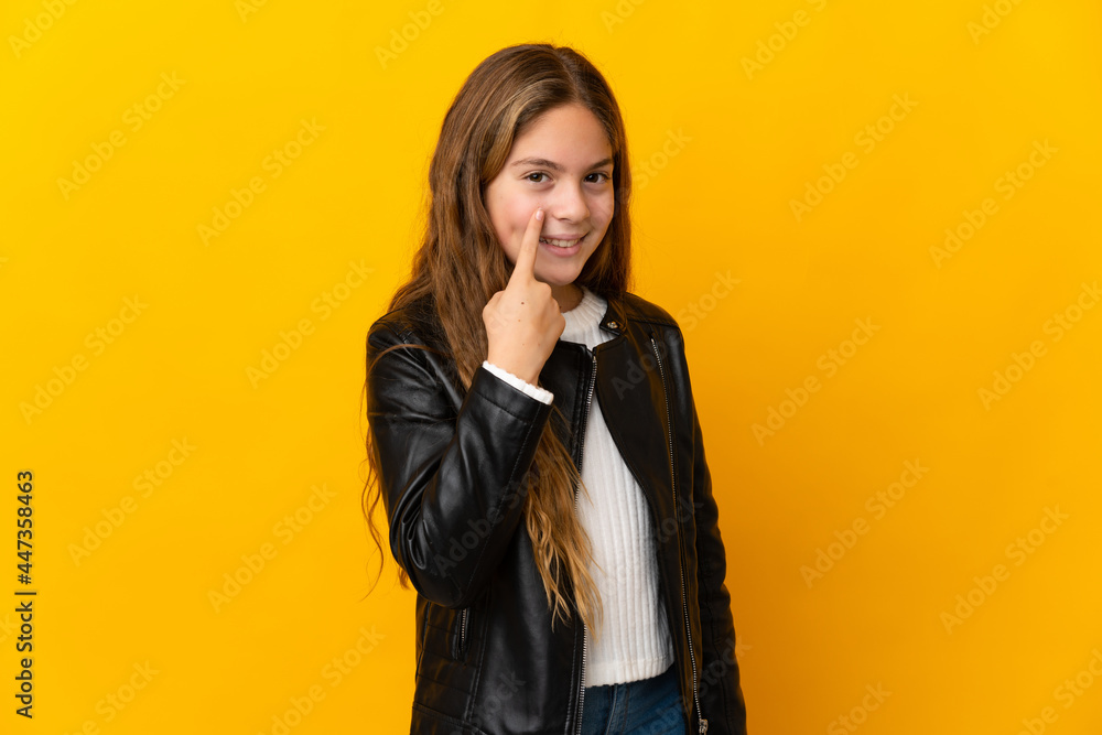 Child over isolated yellow background showing something Child over isolated yellow background showing something