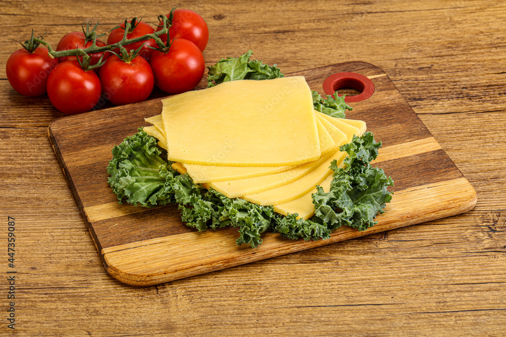 Sliced Gauda cheese over board Sliced Gauda cheese over board