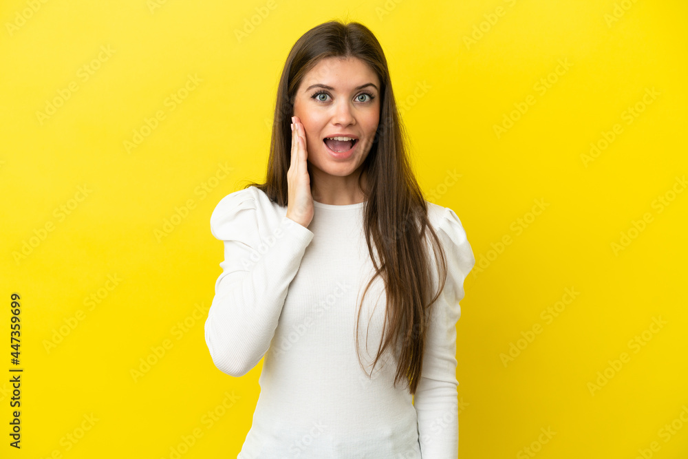 Young caucasian woman isolated on yellow background with surprise and shocked facial expression Young caucasian woman isolated on yellow background with surprise and shocked facial expression
