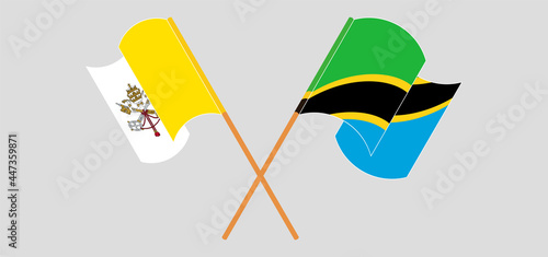 Crossed and waving flags of Vatican and Tanzania