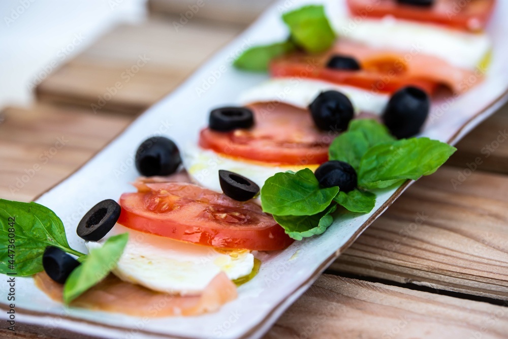 Caprese salad with black olives