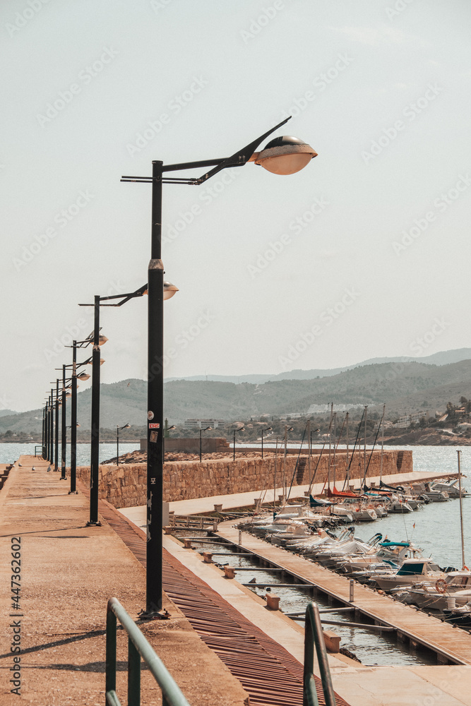 Beni Carlo, Peniscolla, Spain 07-26-2021: light poles next to a beach