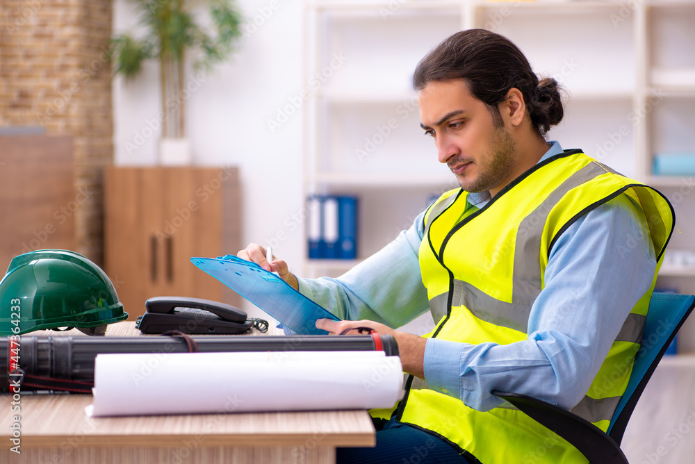 Young male architect working in the office Young male architect working in the office