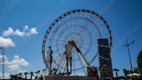 Batumi, Georgia - Moving sculptures of Ali and Nino in front of the Ferris wheel 4k uhd timelapse video