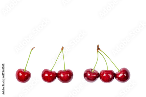 One, two and three Ripe red sweet cherry isolated on white background. Macro photo close up