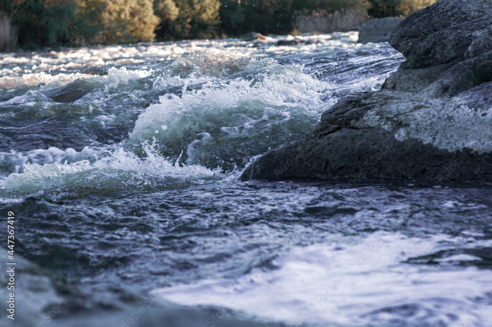 Background, top view, rapid flow river with dark blue water and white foam waves Background, top view, rapid flow river with dark blue water and white foam waves