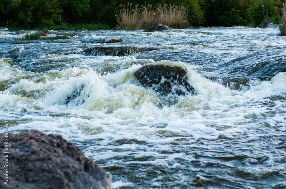 Rocky fast river. Running water, flowing with rapids, vertical photo Rocky fast river. Running water, flowing with rapids, vertical photo