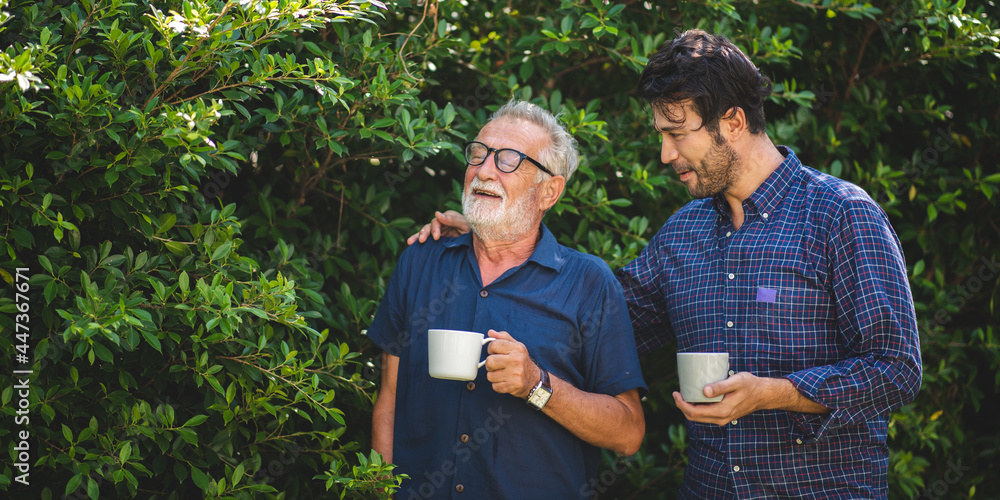 adult son and elderly senior father talking together and holding coffee cup in the garden, happy morning lifestyle of man generation family, love day at home adult son and elderly senior father talking together and holding coffee cup in the garden, happy morning lifestyle of man generation family, love day at home