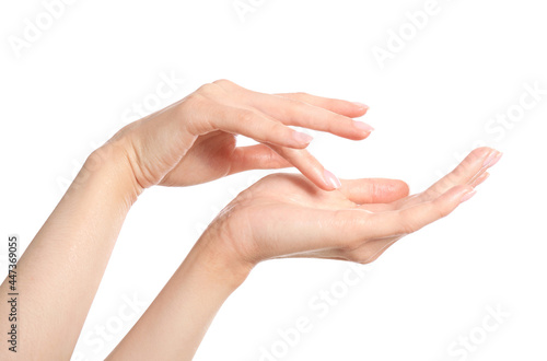 Young woman applying something onto her hands on white background, closeup