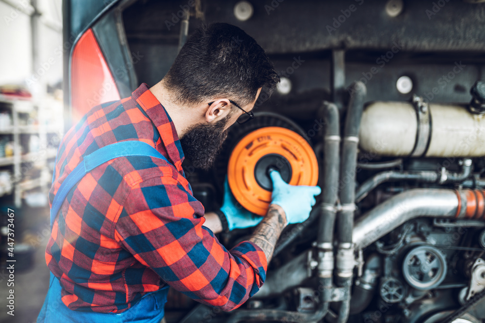 Professional bus mechanic working in vehicle repair service.