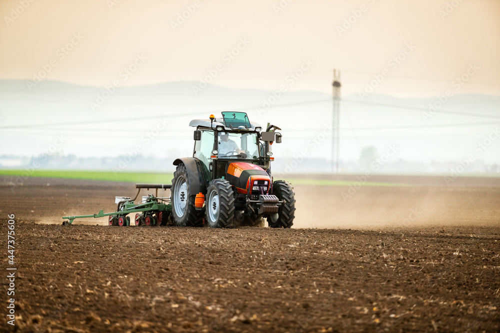 Farmer seeding, sowing crops at field. Sowing is the process of planting seeds in the ground as part of the early spring time agricultural activities. Farmer seeding, sowing crops at field. Sowing is the process of planting seeds in the ground as part of the early spring time agricultural activities.