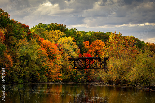Bright Blazing Colors On An Autumn Day At Grand Ledge By Old Rail Road Trestle Over The Grand River