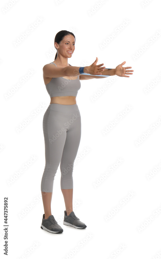 Woman doing sportive exercise with fitness elastic band on white background