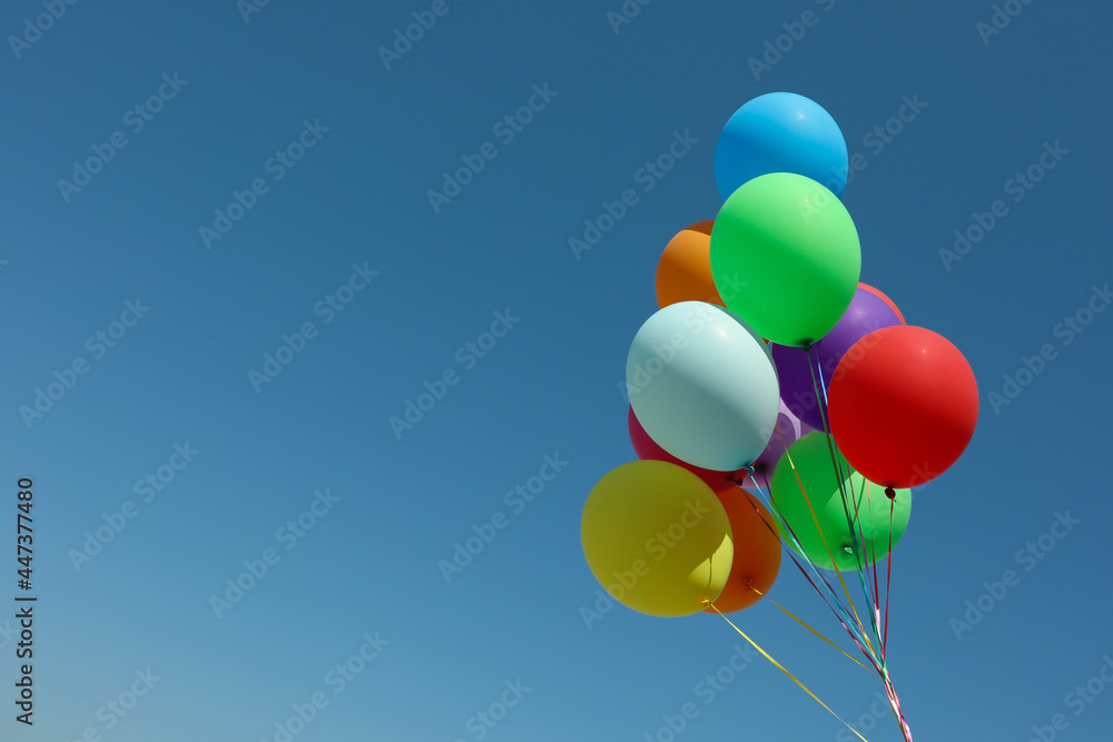 Bunch of colorful balloons against blue sky. Space for text Bunch of colorful balloons against blue sky. Space for text