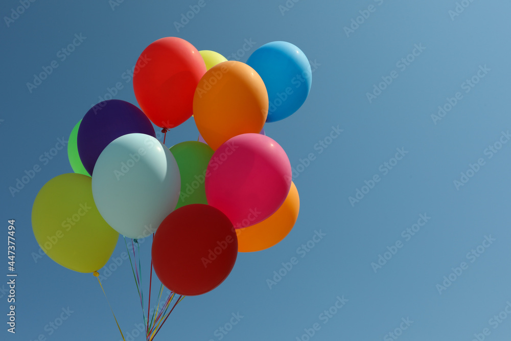 Bunch of colorful balloons against blue sky. Space for text Bunch of colorful balloons against blue sky. Space for text